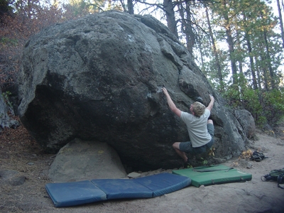Dane Peterson stretching for his next hold - Widgi Creek Bouldering - Bend, Oregon