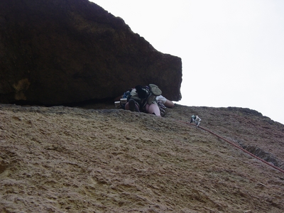 Joel Hass leading from under the roof on the second pitch - Spiderman 5.7 - Trad Route